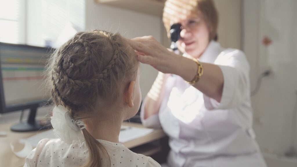 Female Optometrist Checking Child in Her Clinic Photo