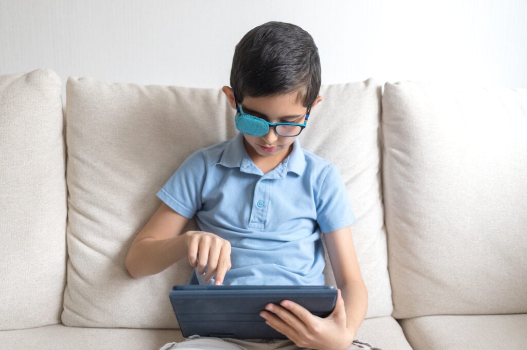 Portrait of Boy in Glasses with Amblyopia Patch for Glasses Photo