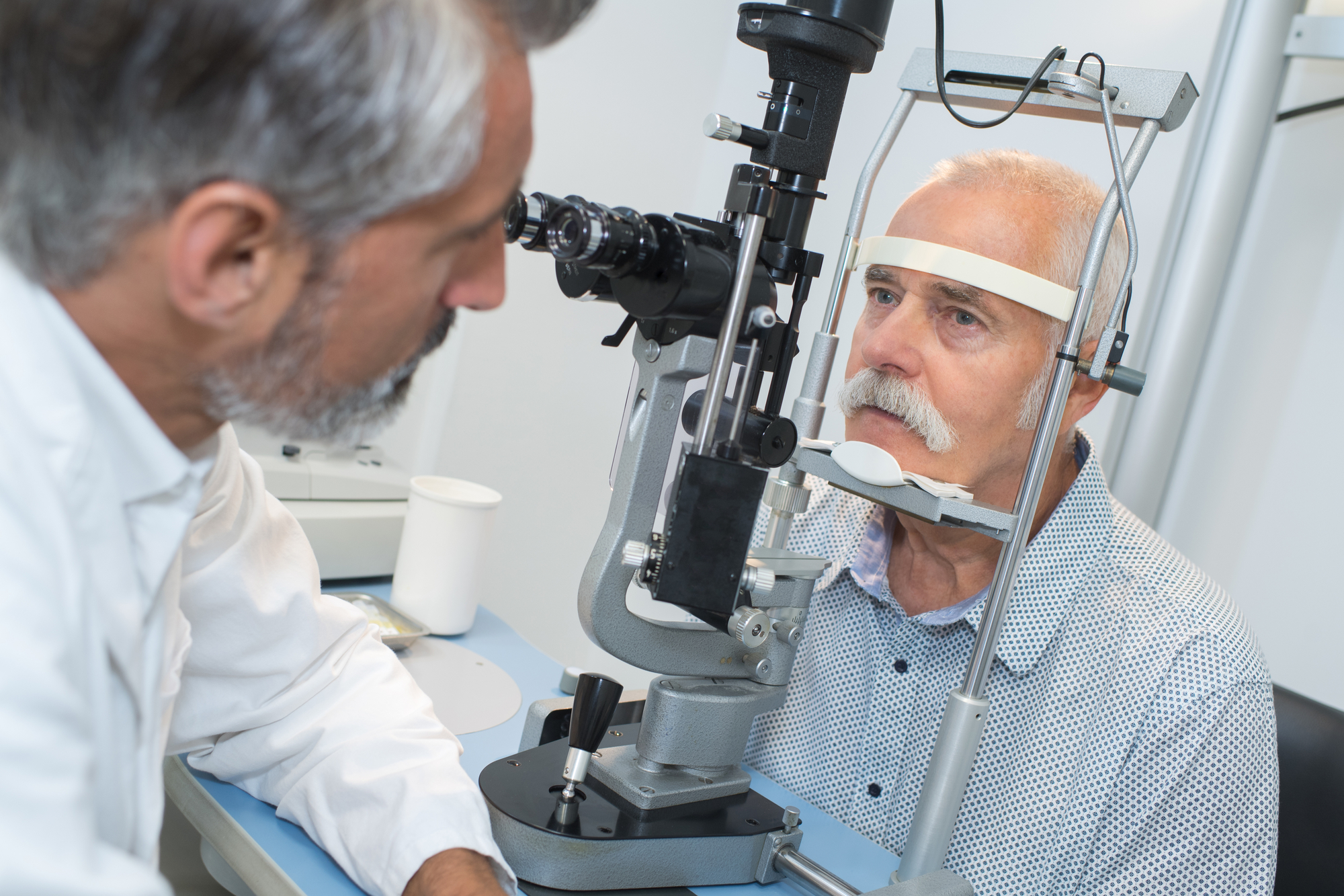 Elderly Man with Glaucoma at the Optician for Optical Exam Photo
