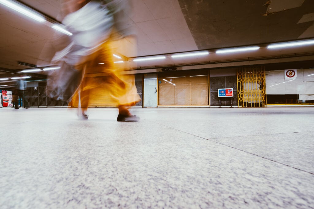 Woman walking fast in the subway blurred depicted s blurred due to motion blindness