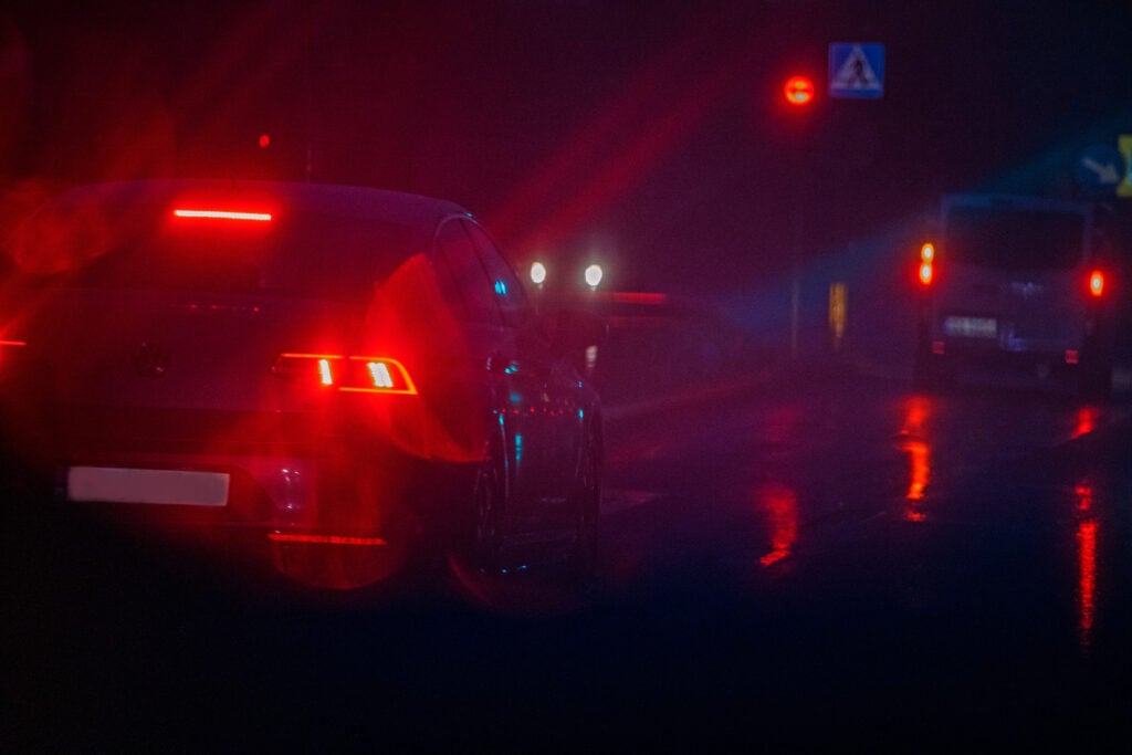 Poor visibility on a rainy night on a motor road. through the windshield a manifestation of choroideremia and night blindness