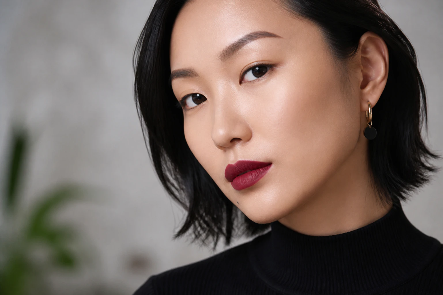 Lovely Asian woman with dark, near-black eyes pictured in the studio