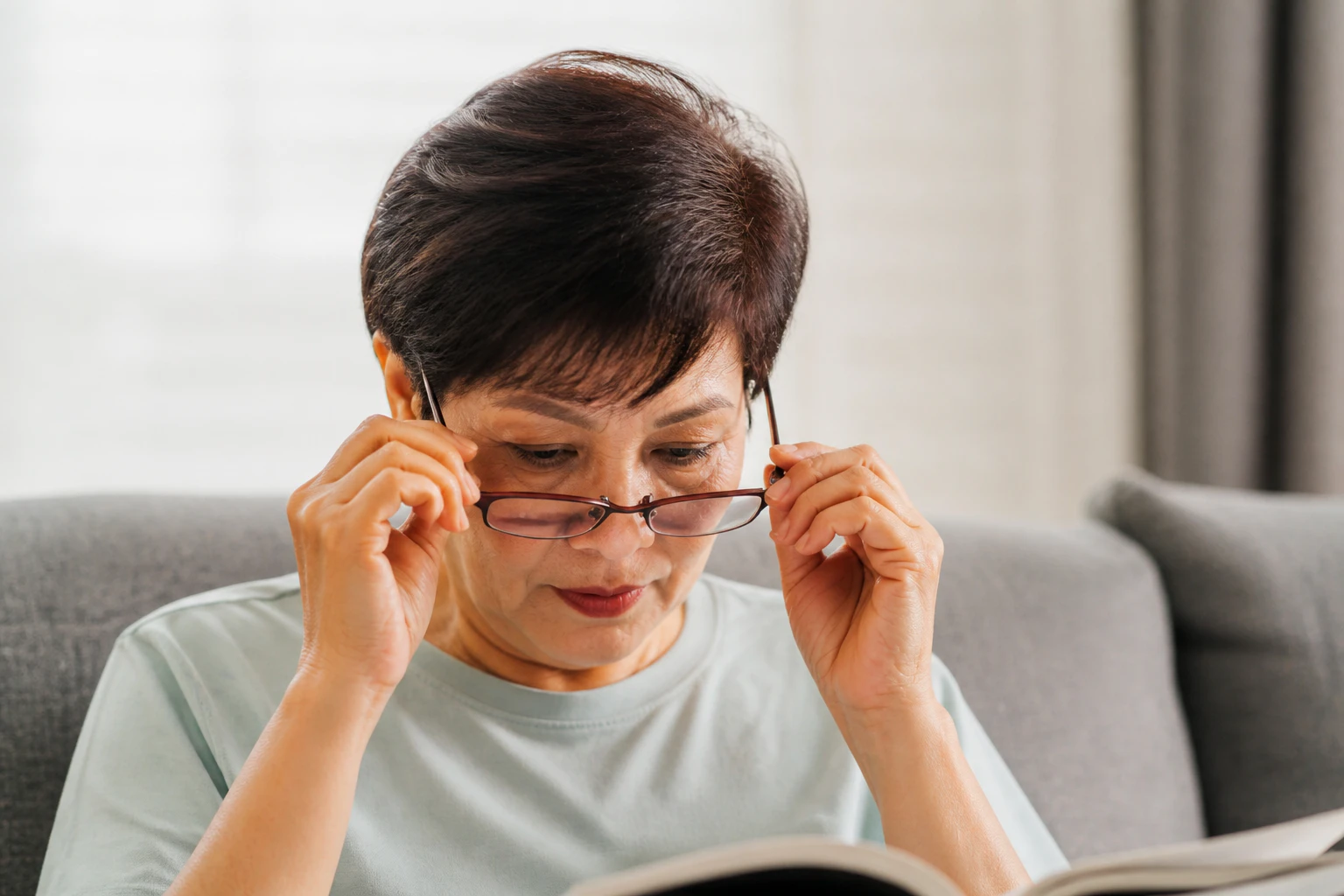 Mature Asian woman wearing eyeglasses