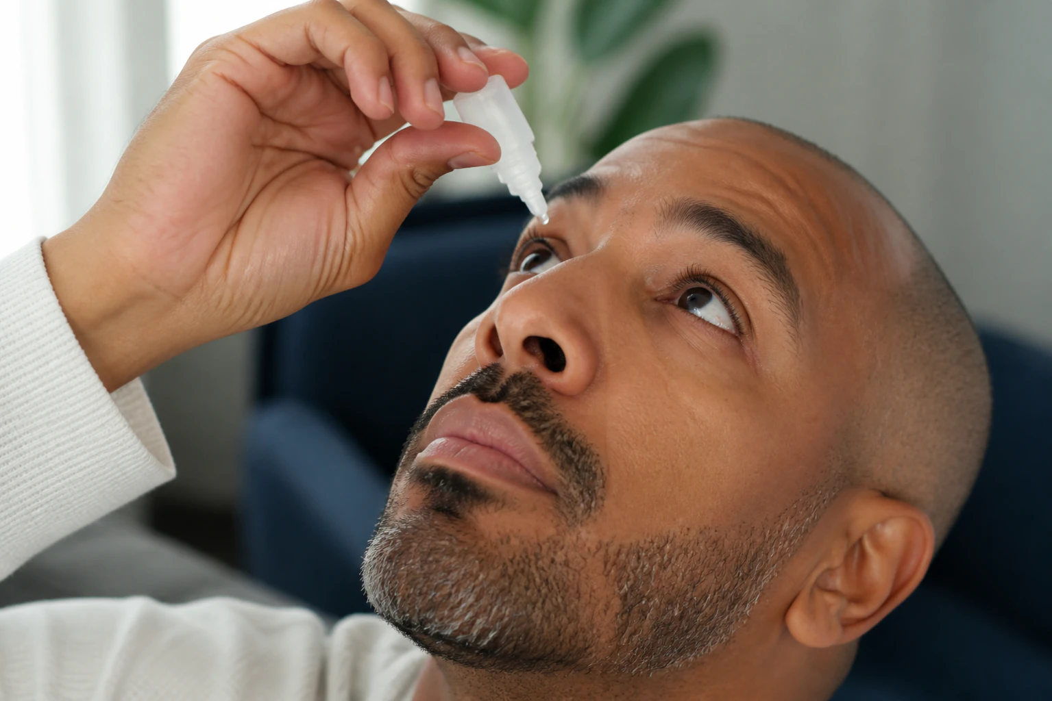 Closeup View of Man Using Eye Drops Made of Ofloxacin Solution