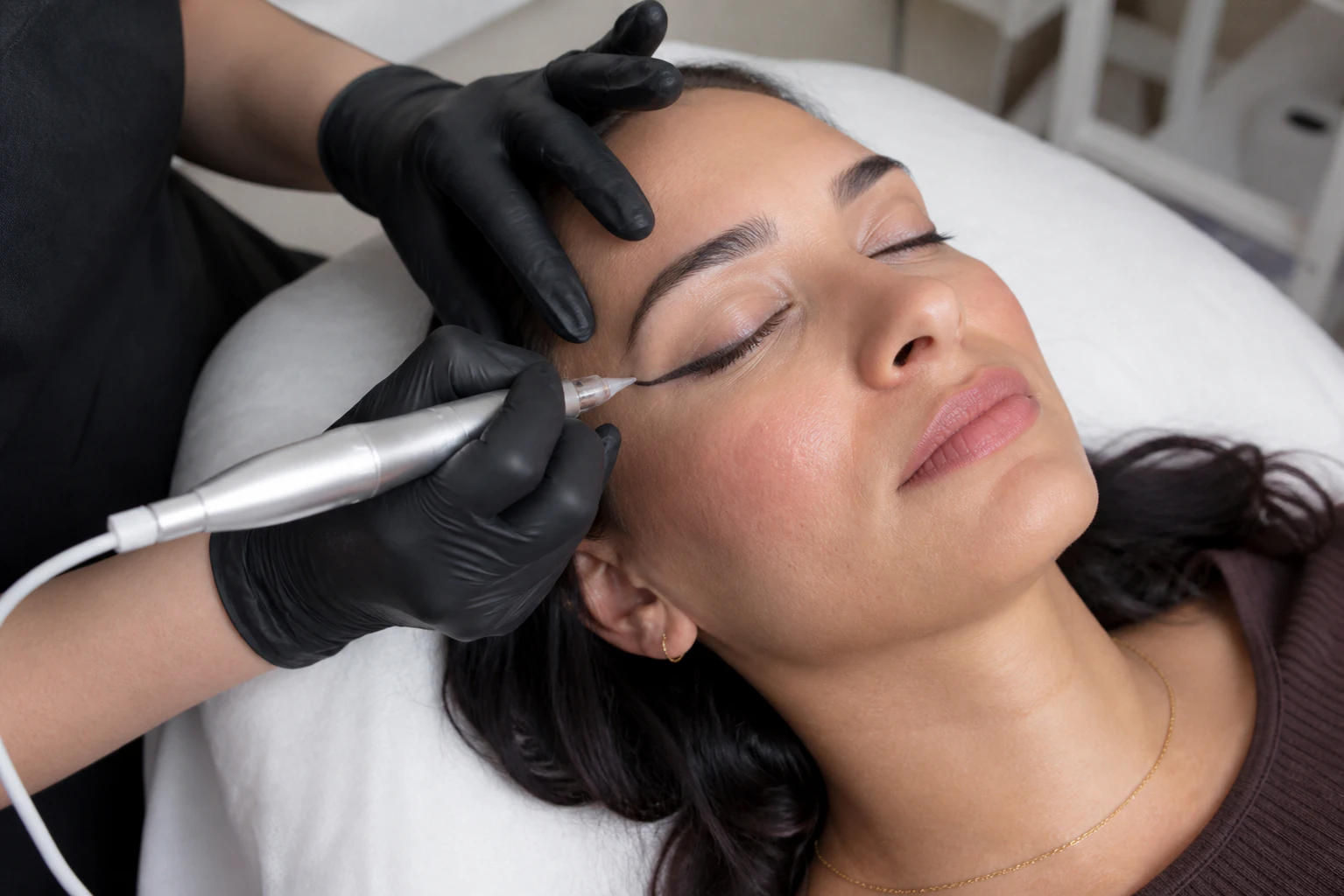 Cosmetologist making permanent makeup