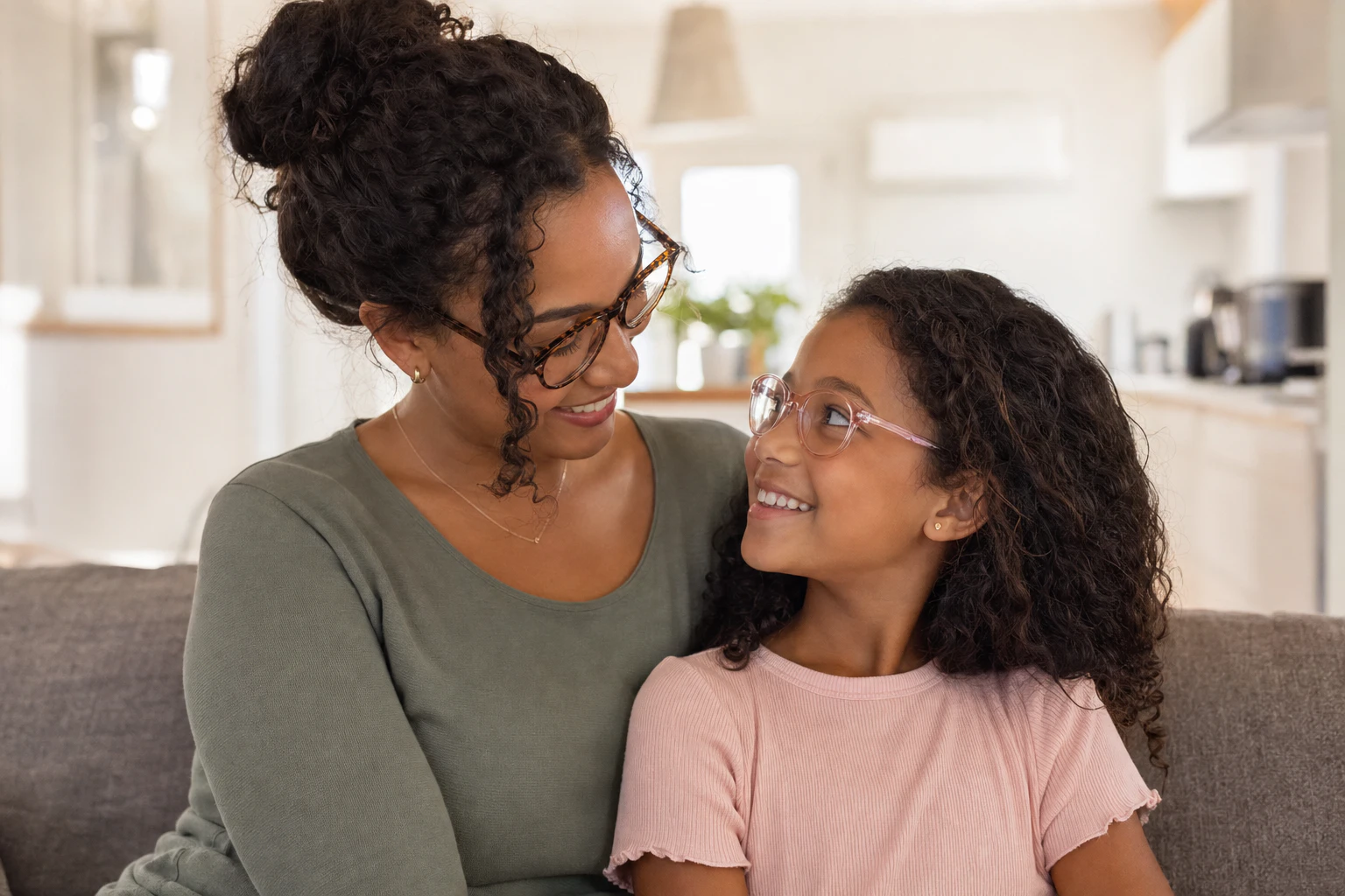 mother and daughter with eyeglasses bond and smile