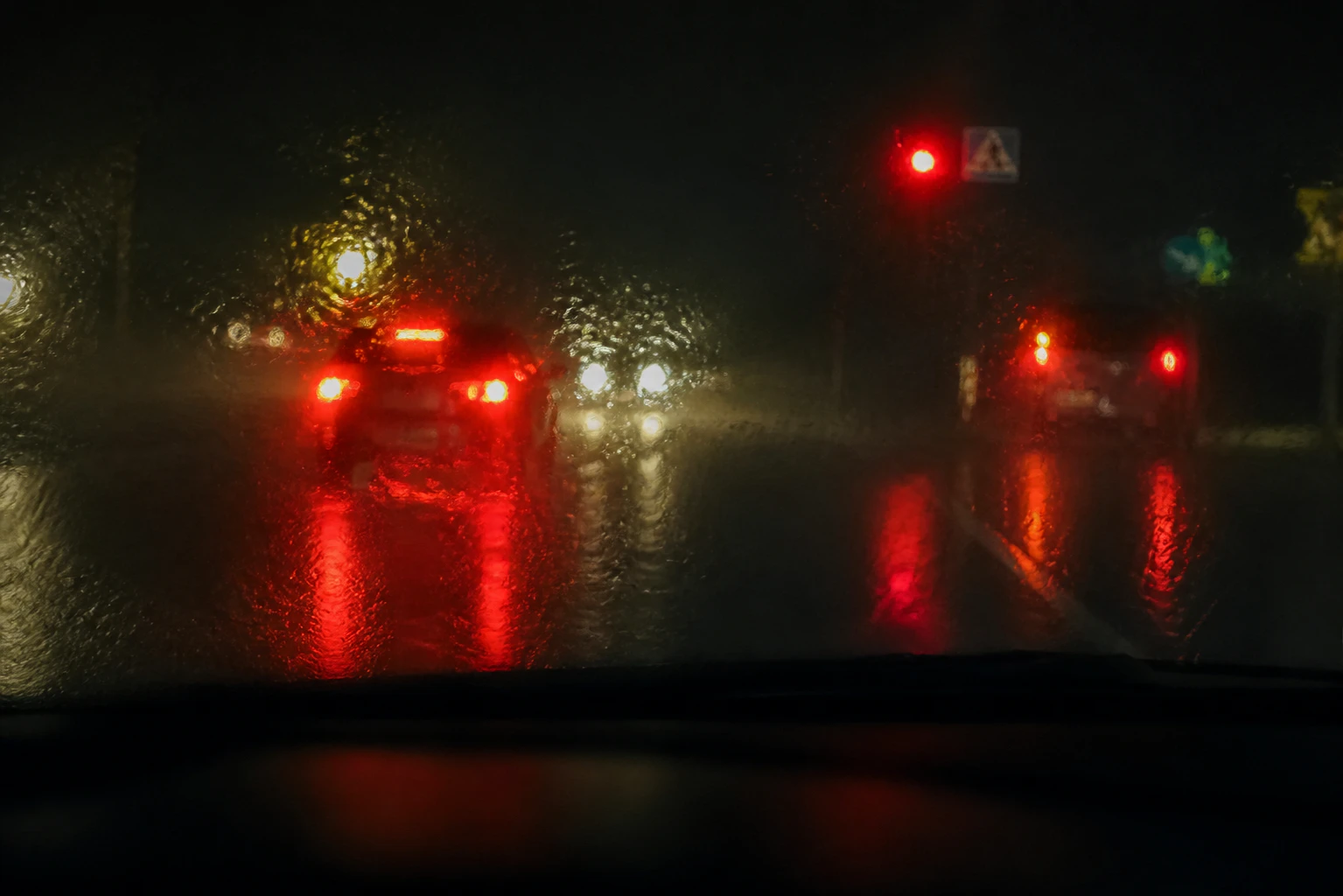 Poor visibility on a rainy night on a motor road. through the windshield a manifestation of choroideremia and night blindness