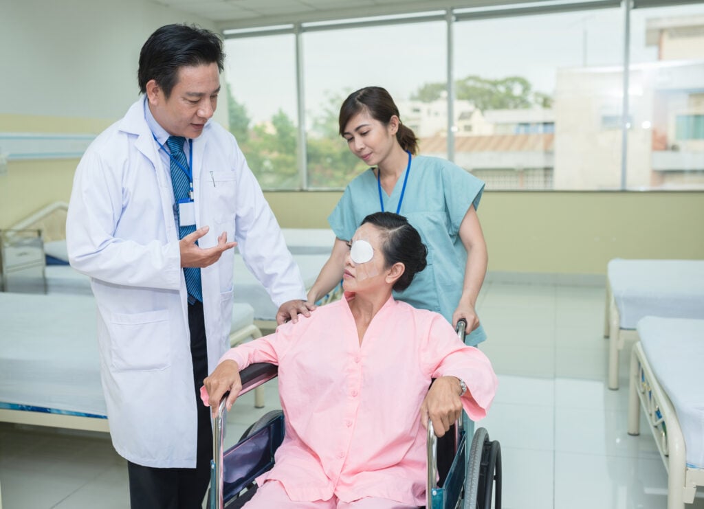 Is Cataract Surgery Painful? 6 Female patient being transported through a wheelchair talks to a doctor after her cataract operation
